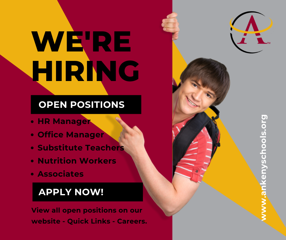 student pointing to we are hiring sign